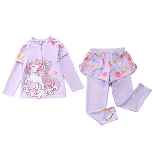 Detail of girls two-piece swimsuit with long sleeves, unicorn print, and floral patterns