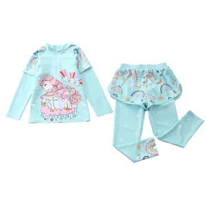 Detail of girls two-piece long sleeve swimsuit with unicorn print and mesh skirt leggings