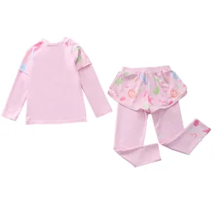 Detail of pink long-sleeve kids' swimwear with ocean-themed prints and skirted pants