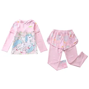 Detail of girls' long sleeve swimwear set featuring unicorn print and ruffled shorts overlay
