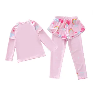 Detail of girls' long-sleeve swimwear featuring rainbow prints and skirted waist
