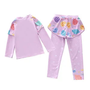 Detail of girls two-piece long sleeve swimsuit set with seashell patterns and star prints