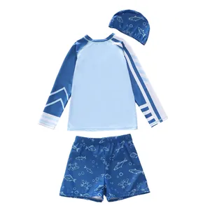 Flachliegendes 3-teiliges Kinder-Langarm-Schwimmset mit Fischmuster auf blauem Stoff