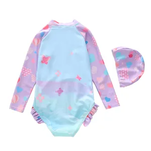 Detail of girls long sleeve swimsuit with heart patterns and purple ruffle trim