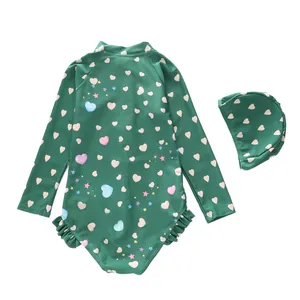 Detail of girls long sleeve swimsuit with heart pattern and double layered ruffles