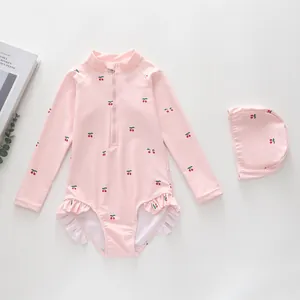 Pink cherry print girls' long-sleeved swimsuit with ruffled edges and matching swim cap