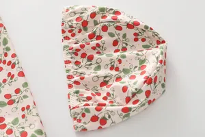 Detail of child swimwear swim cap featuring strawberry floral print and elastic ruffle edge
