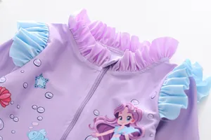 Detail of girls' lilac swimsuit featuring mermaid print, ruffles, and front zipper