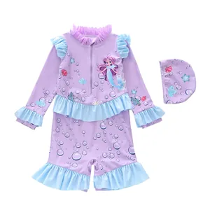 Detailed flat lay of lavender kids swimsuit featuring mermaid print and ruffle trim