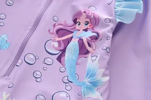 Detail of mermaid print on purple kids swimwear with ruffled blue trim and a front zipper
