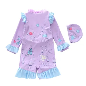 Detail of girls long sleeve one-piece swimsuit with ocean theme prints and ruffled edges