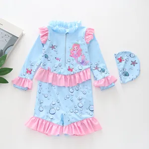 Flat lay detail of blue long sleeve girl's swimsuit with ruffles and mermaid print