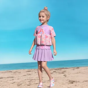 Detail of girls' mermaid buoyancy swimsuit featuring built-in floats and pleated skirt