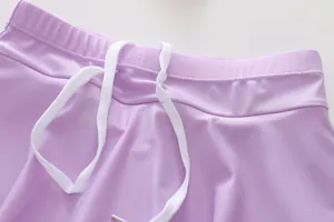 Detail of light purple swim skirt featuring elastic waistband and white braided drawstring