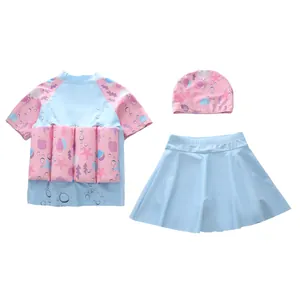 Detailed view of girls three-piece flotation swimsuit with ocean shell and starfish patterns
