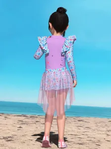 Detail of girls long sleeve swimsuit with shell starfish print and pink mesh skirt