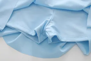 Detail of blue girls' skort showing built-in safety lining and high-elastic quick-dry fabric
