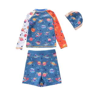 Detailed view of kids' long sleeve swim set with space planet patterns and orange sleeve