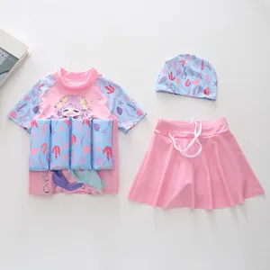 Detailed flat lay of girl's three-piece float suit with mermaid print and swim cap