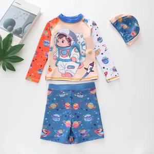 Close-up of boys' three-piece swimwear featuring cartoon astronaut and space planet prints