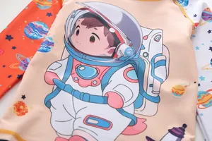 Detail of high-stretch kids' long sleeve swimwear with astronaut print and stitching