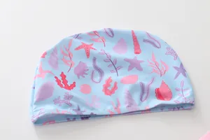 Detail of light blue swim cap for girls with ocean shell and starfish patterns