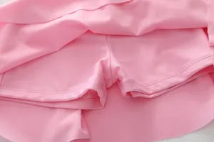 Detail of girls' swim skort showing the built-in safety lining and pink elastic fabric