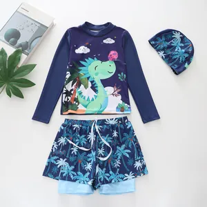 Three-piece boys' swimwear set with long-sleeve cartoon dinosaur top and palm print trunks