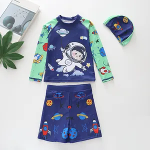Detailed flat lay of three-piece boys swimwear set with astronaut and space pattern
