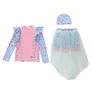Three-piece mermaid style kids swimsuit with ruffles, ocean prints and a blue mesh skirt
