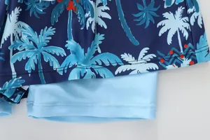 Close-up of boys quick-dry swim trunks with tropical palm tree print and double stitching