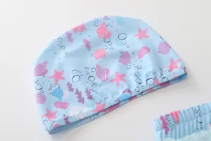 Detail of light blue swim cap for girls with pink and purple ocean starfish patterns