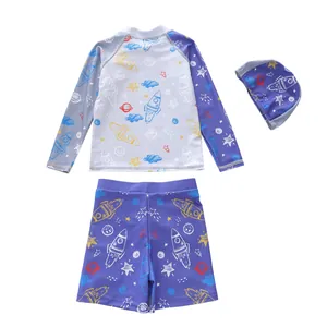Detailed view of kids' 3-piece swimwear with cartoon rocket and planet space prints