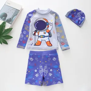 Detailed flat lay of three-piece boys' swimwear set with astronaut and space motifs