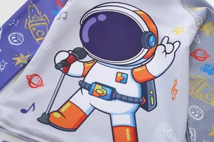 Detailed view of kids long sleeve swimwear featuring a cartoon astronaut singing print