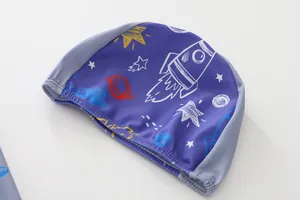 Close-up of quick-dry kids swim cap featuring space rocket and stars pattern