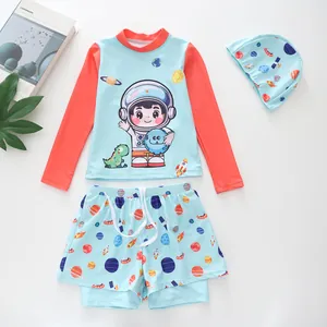 Detailed flat lay of boys' 3-piece swimwear with astronaut and dinosaur space prints
