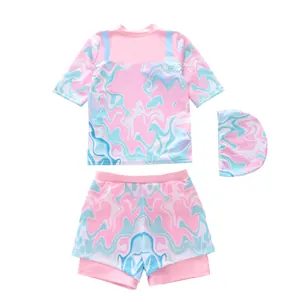 Detailed flat lay of a girls' marble print three-piece swimsuit with swim cap