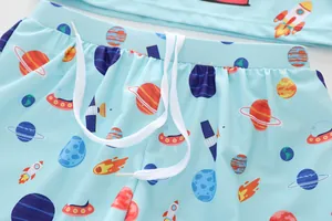 Detail of space-themed boys swim shorts with rocket print and elastic drawstring waist