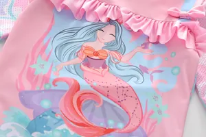 Detail of pink girls swimsuit featuring mermaid print with ruffle neck and cute bow tie
