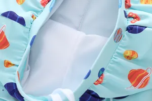 Detail of boys swimwear showing breathable mesh lining and space pattern prints