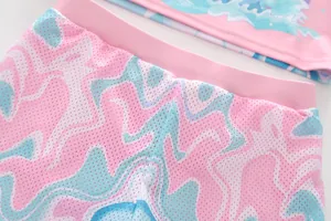 Detail of girls swimsuit bottoms featuring pink elastic waistband and breathable mesh fabric