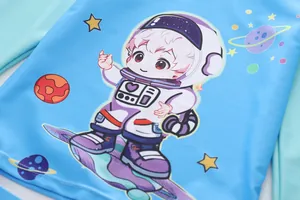Detailed view of kids cartoon astronaut print on blue and green long sleeve swimwear