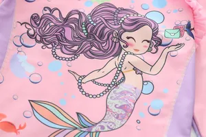 Detailed view of pink mermaid cartoon print with purple ruffles on children swimwear