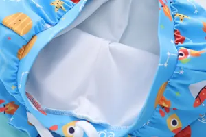 Detail of boys' swim shorts featuring breathable mesh lining and colorful space print