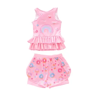 Detail of girls two-piece pink swimsuit with rainbow print and ruffled donut hem