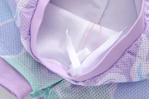 Macro shot of purple camo mesh fabric shorts with elastic waistband and white drawstring