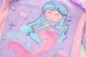 Close-up of ruffled mermaid prints on purple and pink two-piece kids' swimwear