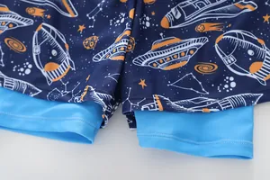 Detail view of boys' double-layer swimming shorts with space print and sky blue lining