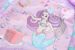 Macro detail of mermaid pattern print on pink fabric for girls' ruffled swimwear